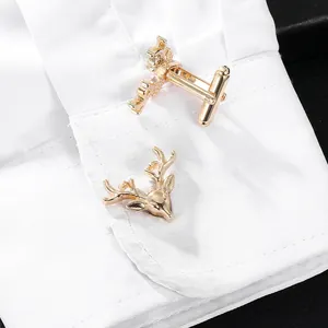 Elegant gold deer head cufflinks for men's shirts shown on a white striped cuff