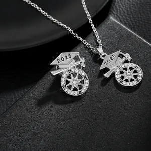 Macro shot of 2025 graduation cap necklace with sparkling compass pendant detail