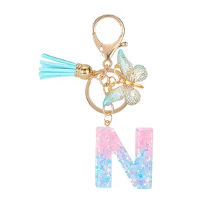 Sequin resin letter N keychain with blue tassel and gold butterfly charm for bags
