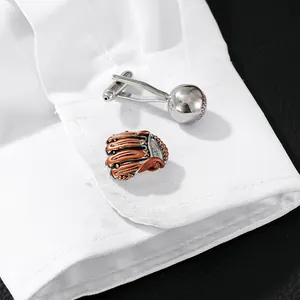 Silver baseball and bronze glove cufflinks set on a white shirt cuff for sports fans