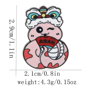 Pink cartoon snake zodiac brooch with lion dance hat and dimensions 2.9cm by 2.1cm