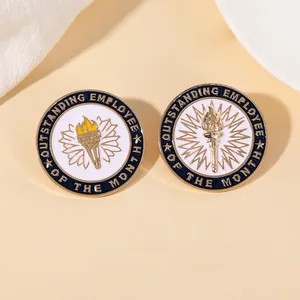 Detail of blue enamel Outstanding Employee of the Month pins with gold torch emblem