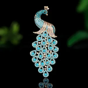 Exquisite peacock brooch with blue rhinestones and gold metal plating on black background