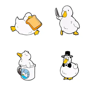 Set of four cute cartoon white duck enamel pins in various playful poses for decoration