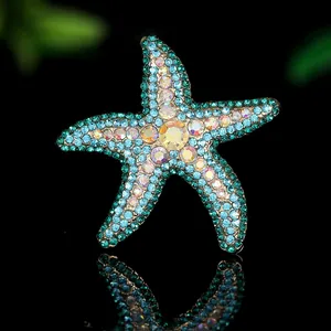 Macro shot of starfish brooch with sparkling blue rhinestones and iridescent crystals