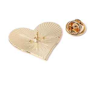 Back view of heart-shaped gold enamel pin with butterfly clutch and textured metal finish