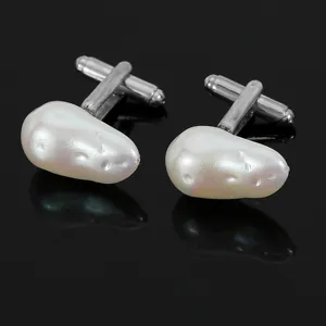 Vue détaillée de boutons de manchette argentés avec perles baroques et reflets brillants
