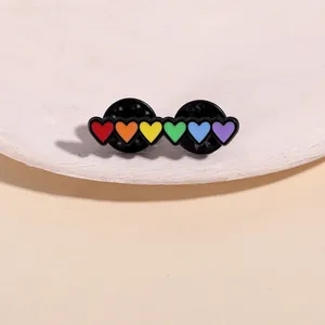 Detail of rainbow heart enamel brooch with six colorful hearts and double pin back closure