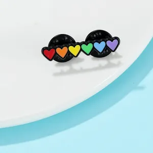 Detailed view of rainbow heart enamel pin featuring six vibrant colors with secure dual backs