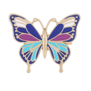 Broche papillon exquise en émail bleu et violet avec placage en métal doré