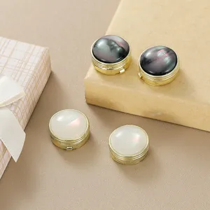 Detailed view of luxury gold cufflink set with black and iridescent pearl inlays
