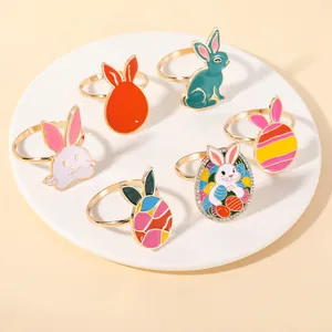 Detail view of 6 colorful Easter napkin rings with bunnies and eggs on a white plate