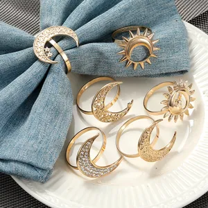 Detail of 6-piece gold metal napkin rings featuring sun and moon celestial designs