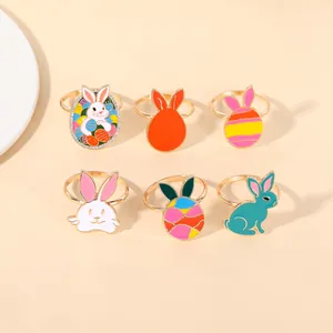 Detail view of 6 colorful Easter napkin rings with gold bunny and enamel egg designs