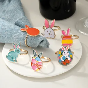 Detailed macro of six colorful Easter bunny and egg napkin rings on a white ceramic plate