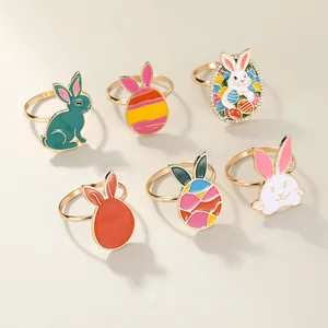 Detailed close-up of colorful enamel Easter bunny and egg metal napkin rings set of 6