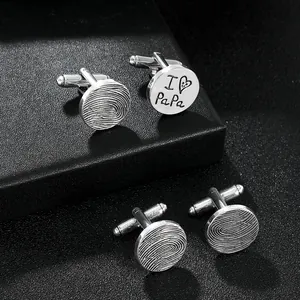Detailed macro view of silver shirt cufflinks with I love Papa and fingerprint engraving