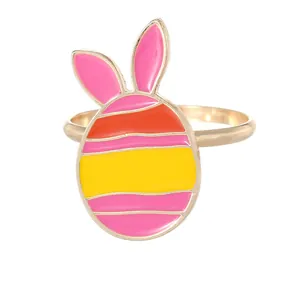 Colorful Easter egg napkin ring with pink bunny ears on a golden metal base