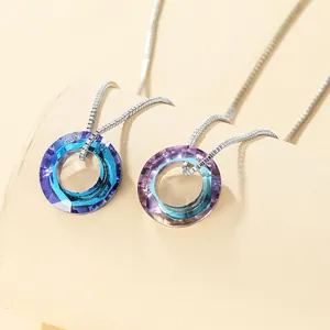 Detailed macro view of faceted gradient crystal pendants in blue and purple on box chains
