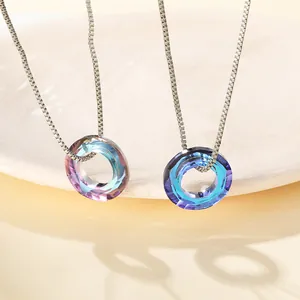 Macro view of faceted circular crystal pendants in iridescent and blue-purple gradients