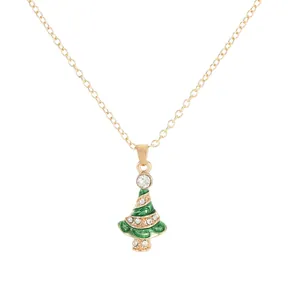 Golden necklace featuring a green enamel Christmas tree pendant with sparkling rhinestones