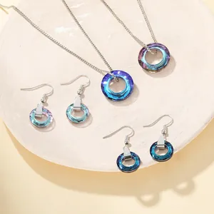 Detail shot of crystal jewelry set with gradient blue-purple faceted round pendants