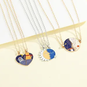 Detailed shot of three couple necklaces with cat and scenery enamel pendants