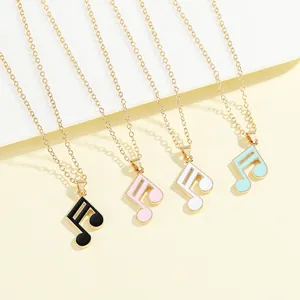 Macro shot of musical note pendants with enamel finish in black, pink, white, and blue
