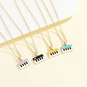 Detail of colorful piano keyboard pendants with enamel finish and gold alloy chains