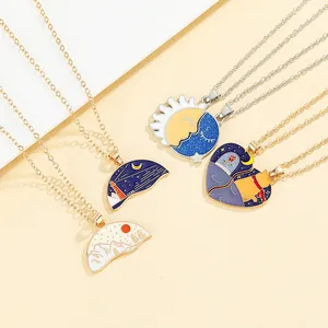 Detail of couple necklaces with enamel sun, moon, mountain landscapes and cat pendants