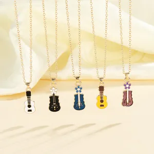 Detail of colorful guitar pendants in gold finish with enamel floral patterns on silk
