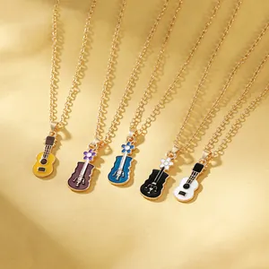 Five colorful enamel guitar and violin pendant necklaces with floral accents on gold chains