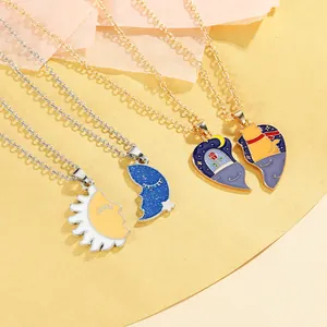 Detail of cartoon cat and moon puzzle necklaces with colorful enamel on gold and silver chains