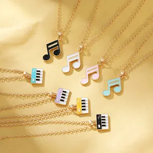 Artistic piano note necklaces with colorful enamel pendants on golden alloy chains