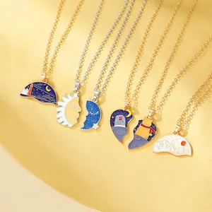 Detail of colorful enamel puzzle necklaces featuring sun, moon, and cat scenery motifs