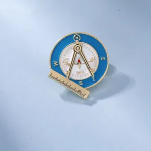 Detailed view of compass and protractor enamel brooch with gold alloy and blue finish