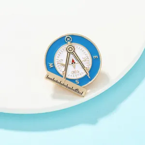 Detailed view of Freemason symbol alloy brooch with light blue enamel and golden compass