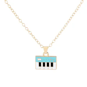 Golden music necklace featuring a piano keyboard pendant with blue enamel finish