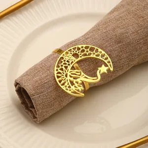 Close-up of golden hollow crescent moon and star napkin ring with intricate geometric patterns