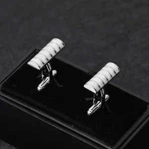 Silver rectangular cuff links with white inlay on black velvet display box for men