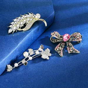 Detailed close-up of luxury rhinestone brooches with pearls on elegant blue velvet fabric