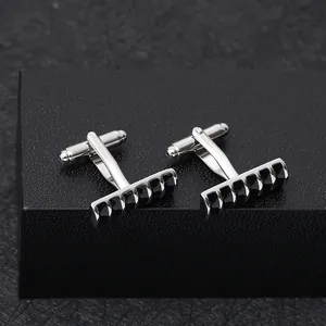 Detailed view of silver cufflinks with black vertical stripes on leather display box
