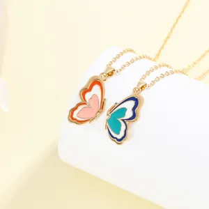 Detailed macro view of colorful enamel butterfly pendants on gold delicate chains