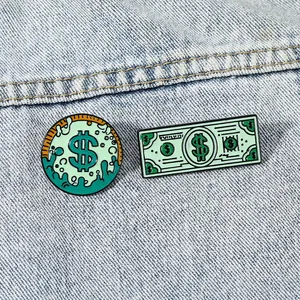 Creative green dollar bill enamel pin set on blue denim fabric for stylish clothing accessory