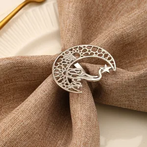 Close-up of silver hollowed moon and star napkin ring on a linen napkin for festive table décor