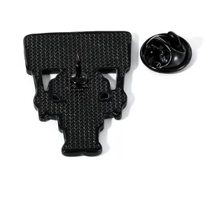 Black enamel astronaut skull pin with metal clutch back on white background