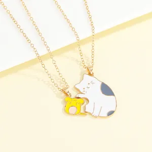 Detail of cartoon cat and mouse couple necklaces with enamel pendants and gold chains