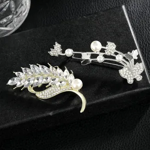Luxurious wheat ear and butterfly brooch pins set with crystals and pearls on black leather