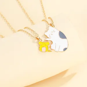 Detailed view of gold puzzle cat and mouse matching pendants for couples