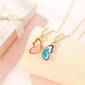 Detail of colorful butterfly wing pendants with gold chains for couples on a display stand